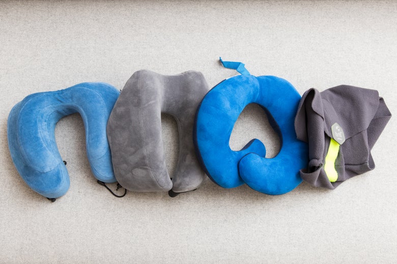 Four travel pillows laid out next to each other in a line.